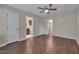 Large bedroom with hardwood floors featuring two doors - one to a bathroom at 4140 Willow Haven Ct, Raleigh, NC 27616