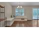 Bright dining area with a window seat, elegant chandelier, and sliding glass doors to the deck at 4140 Willow Haven Ct, Raleigh, NC 27616