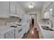 This bright kitchen features white cabinetry, sleek countertops, and stainless steel appliances at 4140 Willow Haven Ct, Raleigh, NC 27616