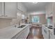 Well-lit kitchen featuring ample counter space, stainless steel appliances, and a view into the dining area at 4140 Willow Haven Ct, Raleigh, NC 27616