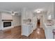 An open concept kitchen with white cabinetry and stainless steel appliances is next to the fireplace at 4140 Willow Haven Ct, Raleigh, NC 27616