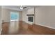 Open-concept living room featuring a fireplace and sliding door access to the deck at 4140 Willow Haven Ct, Raleigh, NC 27616
