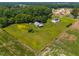 Aerial view of property featuring a well-maintained lawn, a pond, and surrounding greenery at 419 Mabry Rd, Angier, NC 27501