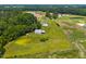 Aerial view showing a pond and surrounding houses with lush greenery and open spaces at 419 Mabry Rd, Angier, NC 27501