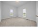 Cozy bedroom with plush carpet, natural light from two windows, and fresh white walls at 419 Mabry Rd, Angier, NC 27501