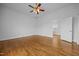 Spacious bedroom featuring hardwood floors, white walls, and a ceiling fan at 419 Mabry Rd, Angier, NC 27501