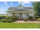Charming home with a covered front porch, beautiful landscaping, and brick pathway leading to the entrance at 419 Mabry Rd, Angier, NC 27501