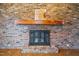 Close-up of the brick fireplace with a rustic wooden mantle at 419 Mabry Rd, Angier, NC 27501