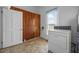 Bright laundry room with wood paneling, tile floor and a washer and dryer at 419 Mabry Rd, Angier, NC 27501