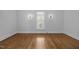 A sunlit living room showcases gleaming hardwood floors and vintage wall sconces at 419 Mabry Rd, Angier, NC 27501