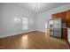 Bright living room featuring hardwood floors, a chandelier, and stainless steel appliances at 419 Mabry Rd, Angier, NC 27501