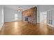 Spacious living room with hardwood floors and a prominent brick fireplace as the focal point at 419 Mabry Rd, Angier, NC 27501