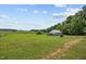 A large property with a farmhouse and a green pasture at 419 Mabry Rd, Angier, NC 27501