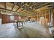 An unfinished space featuring exposed framing and wooden floors provides an opportunity for customization at 419 Mabry Rd, Angier, NC 27501