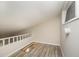 View of unfinished attic storage space with wooden beams and an access window at 4403 Sunburst Ct, Raleigh, NC 27613