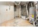 Utility room featuring a water heater, paint cans, and some exposed ductwork at 4403 Sunburst Ct, Raleigh, NC 27613