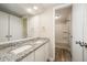Bathroom with granite countertop, double sinks, vanity and access to a shower and tub at 4403 Sunburst Ct, Raleigh, NC 27613