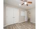 Bedroom featuring a ceiling fan, double closets, a whiteboard, and wood-style floors at 4403 Sunburst Ct, Raleigh, NC 27613