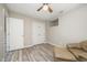 Cozy bedroom featuring a ceiling fan, double closets, a window, and wood-style floors at 4403 Sunburst Ct, Raleigh, NC 27613