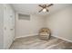 Neutral bedroom featuring a ceiling fan, a double closet, and wood-style floors at 4403 Sunburst Ct, Raleigh, NC 27613