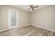 Bedroom with a ceiling fan, vinyl floors, and a glass door for natural lighting at 4403 Sunburst Ct, Raleigh, NC 27613