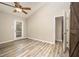Bedroom features wood floors, fan, access to back deck and walk in access to bathroom at 4403 Sunburst Ct, Raleigh, NC 27613