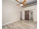 Bedroom featuring wood floors, ceiling fan, natural light and sliding barn door to bathroom at 4403 Sunburst Ct, Raleigh, NC 27613