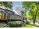 Exterior shot of home reveals multiple decks, mature trees, and landscaped yard at 4403 Sunburst Ct, Raleigh, NC 27613