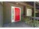 Close-up of the inviting red front door with sidelight, and painted exterior at 4403 Sunburst Ct, Raleigh, NC 27613