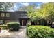 Inviting two-story townhome with a red front door, balcony, and lush greenery at 4403 Sunburst Ct, Raleigh, NC 27613