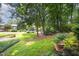 Well-manicured front yard with lush greenery and tree coverage offers curb appeal at 4403 Sunburst Ct, Raleigh, NC 27613