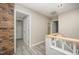Upstairs hallway with brick accent and access to rooms through white doors at 4403 Sunburst Ct, Raleigh, NC 27613