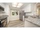 Bright kitchen with white cabinets, granite countertops, and stainless steel appliances at 4403 Sunburst Ct, Raleigh, NC 27613