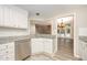 Modern kitchen with white cabinets, stainless appliances, and a view to the living area at 4403 Sunburst Ct, Raleigh, NC 27613