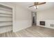Spacious living room featuring wood-look flooring, built-in shelving, and a charming fireplace at 4403 Sunburst Ct, Raleigh, NC 27613