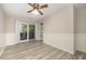 Bright living room featuring stylish floors, a ceiling fan, and sliding glass doors at 4403 Sunburst Ct, Raleigh, NC 27613