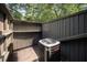 Enclosed patio with wood fencing and exterior shelving units has a modern air conditioning unit at 4403 Sunburst Ct, Raleigh, NC 27613