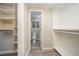 Well-organized walk-in closet with shelving that leads to an en suite bathroom at 4403 Sunburst Ct, Raleigh, NC 27613