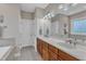 A well-lit bathroom features double sinks, a large mirror, and a tiled floor at 500 Chandler Grant Dr, Cary, NC 27519