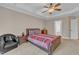 A bright bedroom features a ceiling fan, neutral walls, and access to the ensuite bathroom at 500 Chandler Grant Dr, Cary, NC 27519