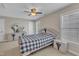 Bedroom with a ceiling fan, windows with blinds and a queen bed with black and gray quilt at 500 Chandler Grant Dr, Cary, NC 27519