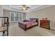 A cozy bedroom with a tray ceiling, ceiling fan, and large window provides a comfortable living space at 500 Chandler Grant Dr, Cary, NC 27519