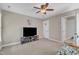 A bright bedroom features a ceiling fan, neutral walls, and easy access to an ensuite bathroom at 500 Chandler Grant Dr, Cary, NC 27519