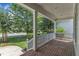 Spacious porch with white railings and brick flooring overlooking a landscaped front yard at 500 Chandler Grant Dr, Cary, NC 27519