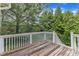 This wooden deck has beautiful tree views and white railings at 500 Chandler Grant Dr, Cary, NC 27519