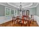 Formal dining room with a classic chandelier, wood floors, and ample natural light at 500 Chandler Grant Dr, Cary, NC 27519