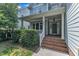 Inviting front entry featuring a brick staircase and covered porch at 500 Chandler Grant Dr, Cary, NC 27519