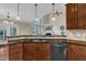 View of the kitchen featuring granite counters, wood cabinets, and stainless steel appliances at 500 Chandler Grant Dr, Cary, NC 27519