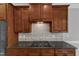 Close-up of gas cooktop and custom cabinetry in the updated kitchen at 500 Chandler Grant Dr, Cary, NC 27519