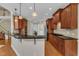 Open kitchen with wood cabinets, breakfast bar, granite countertops, and stainless steel appliances at 500 Chandler Grant Dr, Cary, NC 27519